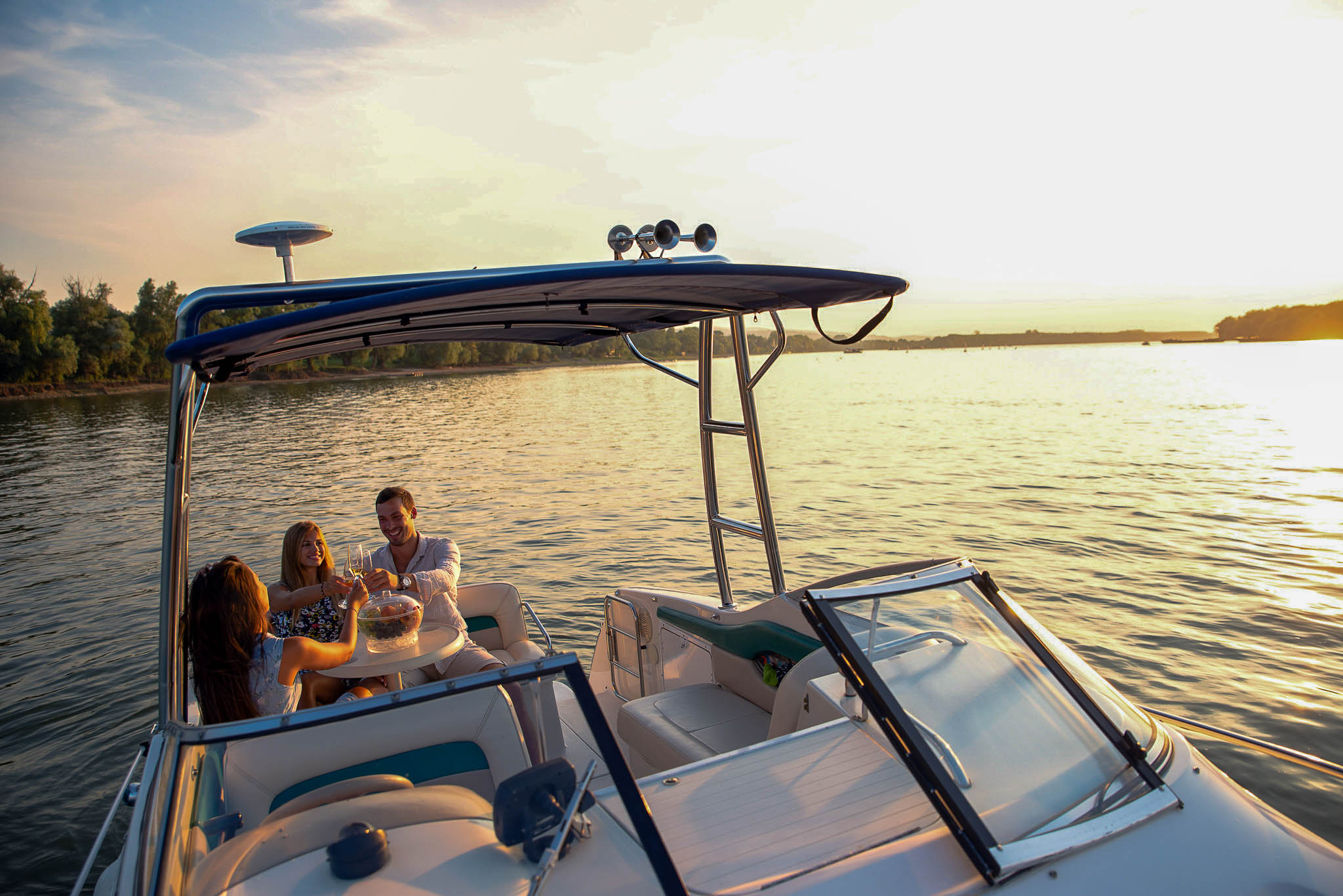 Family on pontoon boat at golden hour